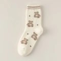 Dicke Korallenfleece-Socken in Creme mit braunem Bärenmuster und gestreiften Bündchen - Weißer Bär