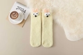 Close-up of yellow coral fleece socks with cute 3D bunny ears for home warmth - One Size / White