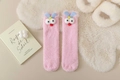 Detail of pink coral fleece thermal socks featuring cute cartoon 3D eyes and blue ears - Pink