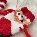 Close-up of fluffy coral fleece Christmas socks featuring a 3D cute cartoon mascot detail - Santa Claus - Red Small Hands