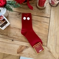 Close-up of red rabbit wool socks with white pom-poms and festive bow details - Red with Plush Balls