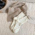 Cream polka dot fuzzy crew socks with brown ruffle trim on a soft plush rug background - One Size / Cream White