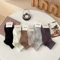 Pack de seis pares de calcetines cortos de hombre en colores neutros sobre mesa - Talla única / Colores Mezclados