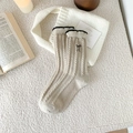 Cozy beige cable-knit wool socks featuring delicate black lace trim and bow embroidery - One Size / Beige