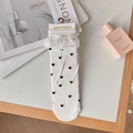 Sweet white Lolita socks featuring black heart prints with lace trim and ribbon bows - One Size / White