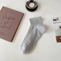Light grey athletic crew sock with breathable mesh and ribbed cuff on a minimal desk - One Size / Light Gray