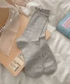 Light gray cotton crew socks with blue textured dots and stylish ruffled lettuce edges - One Size / Light Gray