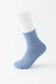 Light blue fuzzy coral fleece socks displayed on a leg mannequin for a soft cozy fit - Blue