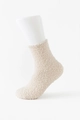 Beige coral fleece socks with thick warm texture on white foot model for winter - Khaki
