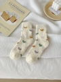 Thick beige coral fleece socks featuring colorful heart patterns on a white knit blanket - One Size / Yellow