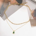 Detail of gold double layer necklace with green rectangular pendant and figaro chain - Green