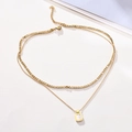 Detail of layered gold stainless steel necklace with square white shell pendant - White