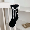 Black Lolita socks with white lace bows and star patterns on a wooden chair - One Size / Black