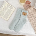 Close-up of soft light blue coral fleece socks with cute brown bear embroidery detail - One Size / Green