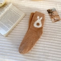 Detail of warm brown coral fleece socks with 3D pom-poms and cute rabbit patterns - Khaki