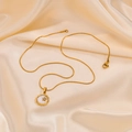 Detailed macro view of a gold-plated shell pendant with a star and sparkling rhinestone - Pendant + Round Snake Chain