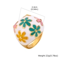Detail view of large white enamel flower ring with golden finish, size and weight specs - US 6 / White Enamel Floral Style (RC-954)