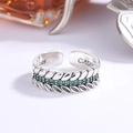 Macro shot of S925 sterling silver wheat ring with green zircons and vintage finish - Green Zirconia Style (KDP1181)