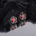 Vintage star earrings with red zircon and aged silver finish on a dark background - Vintage Red Star Style (KDP789)