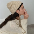 Beige chunky knit wool blend beanie for women shown on model in a minimalist setting - Beige Coffee