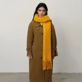Thick bright yellow tassel scarf paired with dark brown wool coat for winter outfit - Turmeric