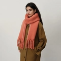 Thick coral fringe scarf with contrast white stitching worn with a camel wool coat - Begonia Red