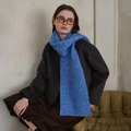 Bright blue knit scarf with rhombus pattern paired with a dark grey wool coat - Sapphire Blue