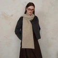 Minimalist beige knitted scarf with diamond pattern worn with a wool coat for winter - Off White