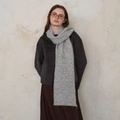 Classic grey knitted scarf with diamond texture worn by a model in a minimal outfit - Light Gray