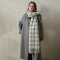 Soft wool scarf in off-white and pale blue check with fringe on a grey wool coat - Light Green Gray