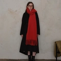 Vibrant red wool blend tassel scarf worn by model with a dark winter coat - Red