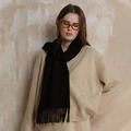 Minimalist black wool tassel scarf for winter, styled with a beige knit cardigan - Black