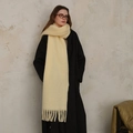 Pale yellow wool blend tassel scarf styled with a black coat for a winter look - Tender Yellow