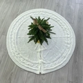 White knitted Christmas tree skirt with cable knit pattern and bow ties on wooden floor - White Ruffled Tie Style A