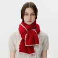 Winter red knitted scarf with white whipstitch edge detail worn over a beige sweater - Red
