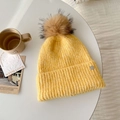 Bright yellow knit beanie with a large faux fur pompom and metal logo for winter warmth - Fresh Yellow