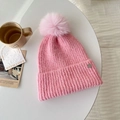 Chic pink knit beanie featuring a large faux fur pompom and metal logo detail - Soft Pink