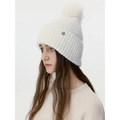 White ribbed knit beanie with a large fluffy pompom and metal logo for winter warmth - Cream