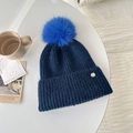 Dark blue chunky knit beanie with vibrant blue pom-pom and silver metal logo tag - Navy Blue