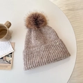 Chunky knit beanie in mixed light brown with a large fluffy faux fur pompom decoration - Oatmeal