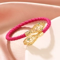 Chic pink braided leather snake bracelet with gold hollow serpent head and green eyes - Pink