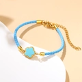 Sky blue woven rope bracelet with gold clover pendant and adjustable metal chain - Light Blue
