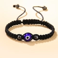 Handmade black braided rope bracelet featuring a blue evil eye bead and metallic accents - Evil Eye Bracelet