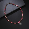 Bohemian wood bead necklace with sun pendant, brown coconut shells and pink accents - Red