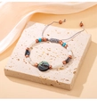 Detail of adjustable woven bracelet with natural abalone shell bead and colorful stones - Round
