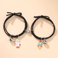 Braccialetti di coppia magnetici con astronauta, ciondoli a razzo e campanelli neri - Stile Magnetico Astronauta e Razzo (Coppia)