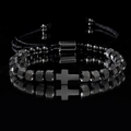 Détail macro du bracelet perlé pour homme avec croix en argent et billes d'acier texturées - Noir