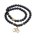 Ethnic matte black beaded bracelet featuring vintage gold Buddha head and Om symbol charms - Black
