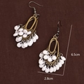 Vintage bohemian bronze drop earrings with white teardrop charms on dark fabric - Antique Bronze With White Beads