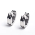 Macro detail of silver stainless steel ear cuffs with industrial vertical grooved texture - Silver